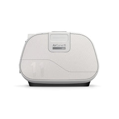ResMed AirCurve 11 ASV device placed on top of a packed travel suitcase, representing portability for use while travelling.