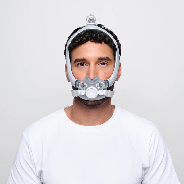Man wearing F30i Mask, he is wearing a white t shirt and is standing infront of a white background